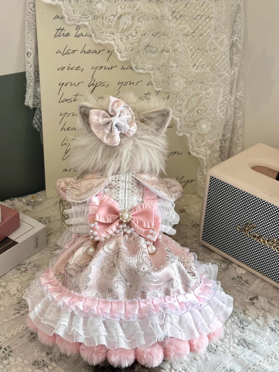 Peach pearl rhinestone pet dress worn by a cat with bow detail